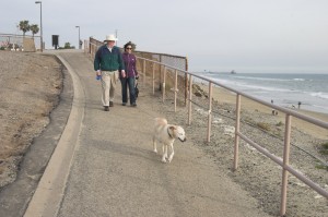 Michele and FIL Alvin walking dogs on beach